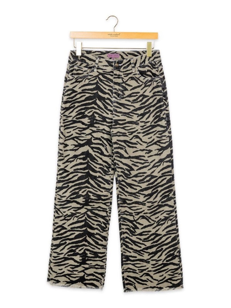 High-rise, wide-leg jeans with bold black and beige zebra print; available in sizes XS–XL.