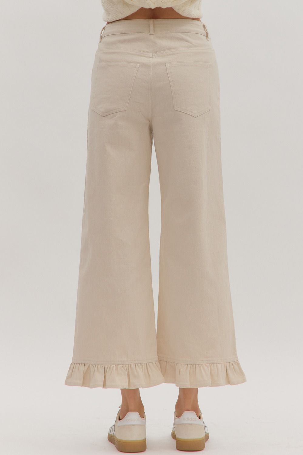 Leah Ruffle Trim Pants in light beige with wide legs and ruffle hems. Available in sizes XS–XL.