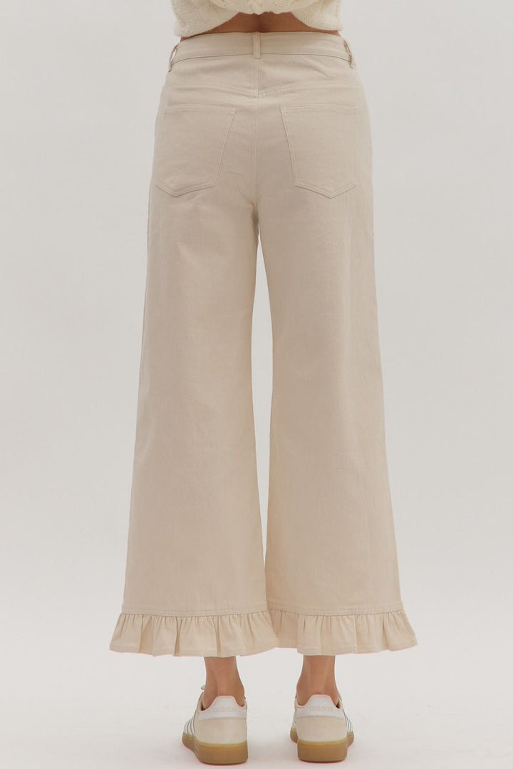 Leah Ruffle Trim Pants in light beige with wide legs and ruffle hems. Available in sizes XS–XL.