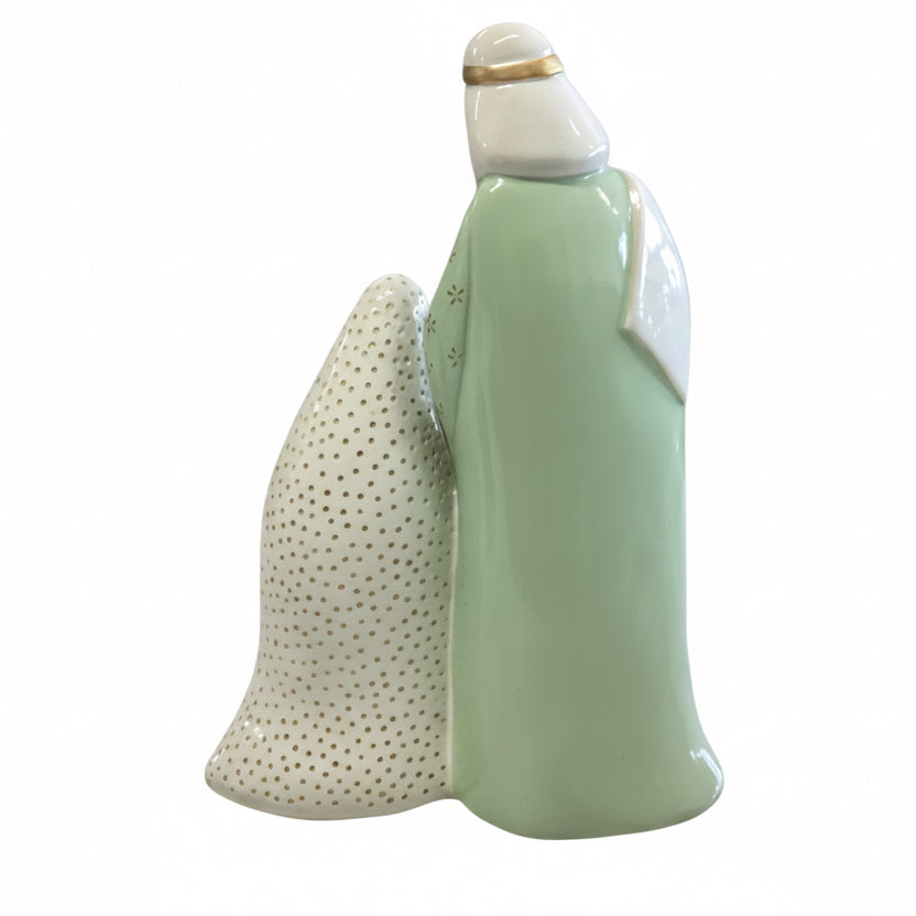 Pastel Nativity figurine with a mint green robed figure and a textured white form with gold dots.