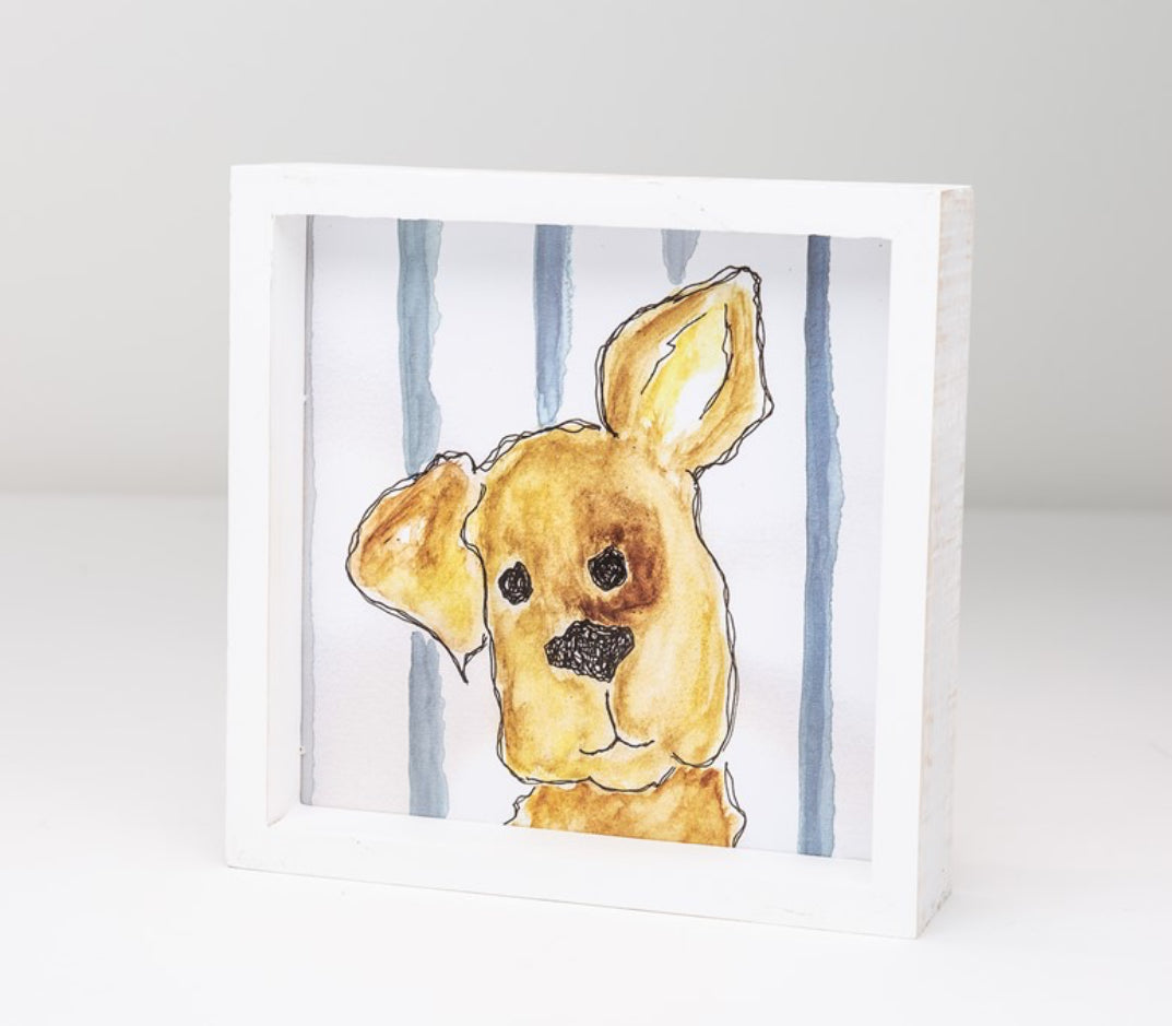 Wooden block sign with blue and white striped background with hand drawn puppy dog with one ear up on middle.