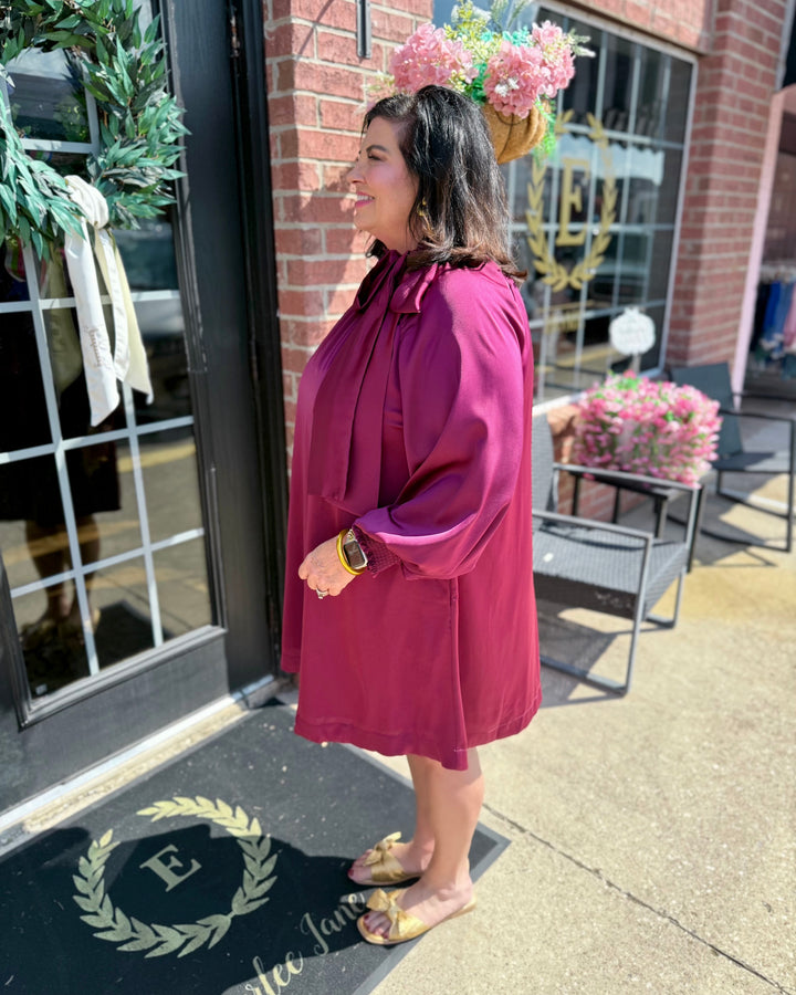 Plum Satin Tie Neck Dress, available in sizes XS-XL; features a tie neck detail.