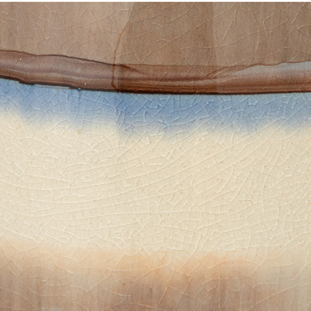 64 oz. stoneware pitcher with brown, blue, and aubergine cream stripes; fine crackle pattern throughout.