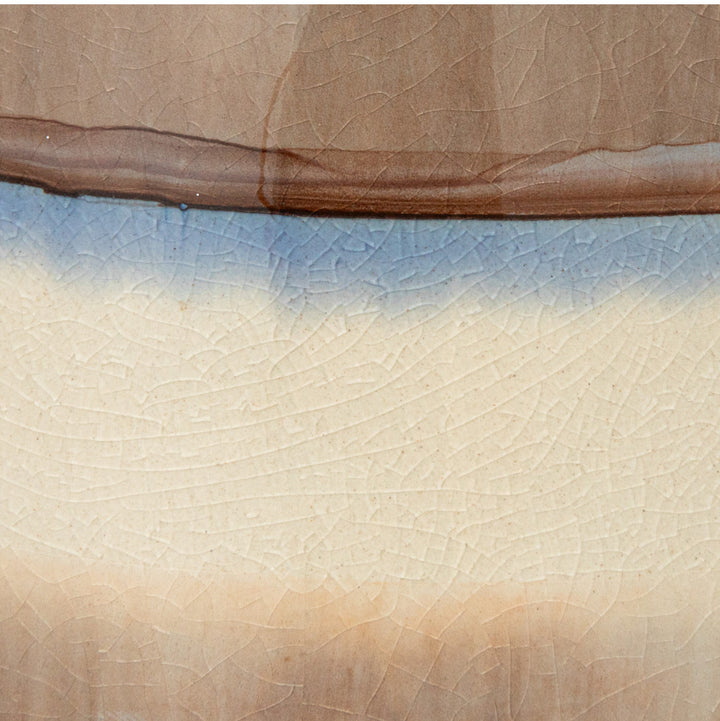 64 oz. stoneware pitcher with brown, blue, and aubergine cream stripes; fine crackle pattern throughout.