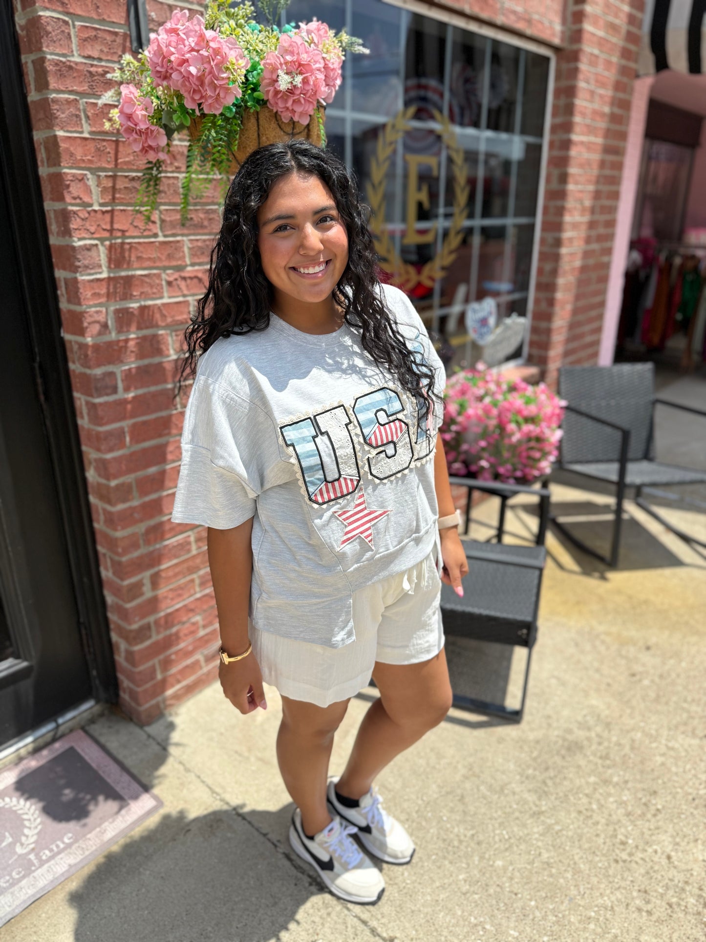 Light gray USA Patch Tee available in sizes S-XL. Features patch detail on front.