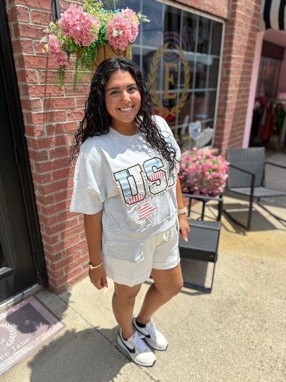 Light gray USA Patch Tee available in sizes S-XL. Features patch detail on front.