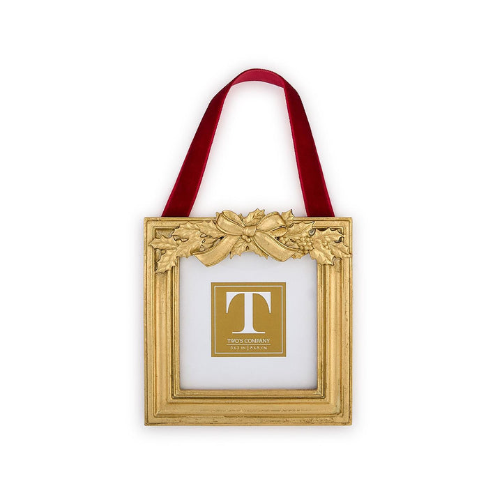 Holly Leaves Ornament Photo Frame with gold-toned holly leaves, a sculpted bow topper, a red velvet ribbon, and a 3x3 inch photo opening.