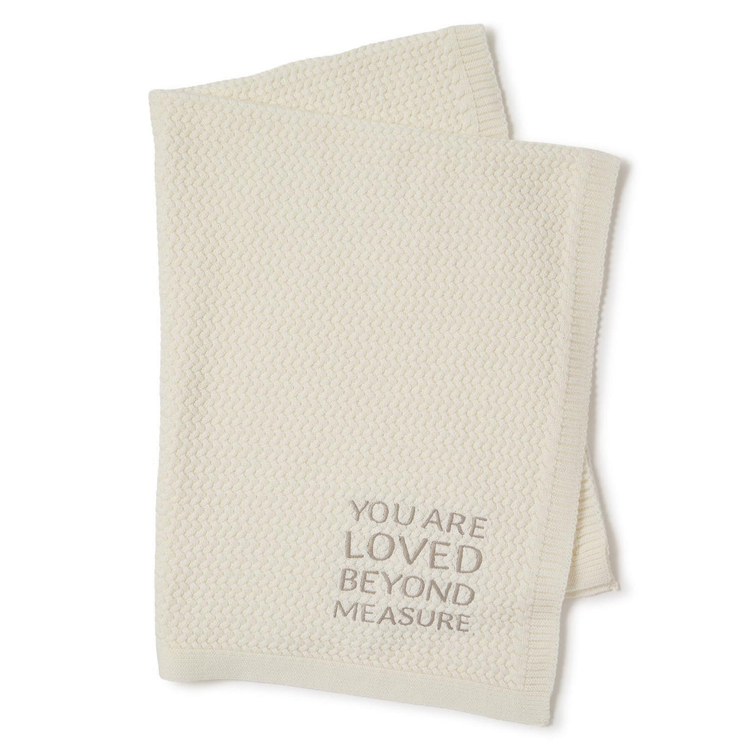 Cream textured knit baby blanket with "YOU ARE LOVED BEYOND MEASURE" in gray. Size: 30"x40".