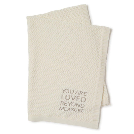 Cream textured knit baby blanket with "YOU ARE LOVED BEYOND MEASURE" in gray. Size: 30"x40".