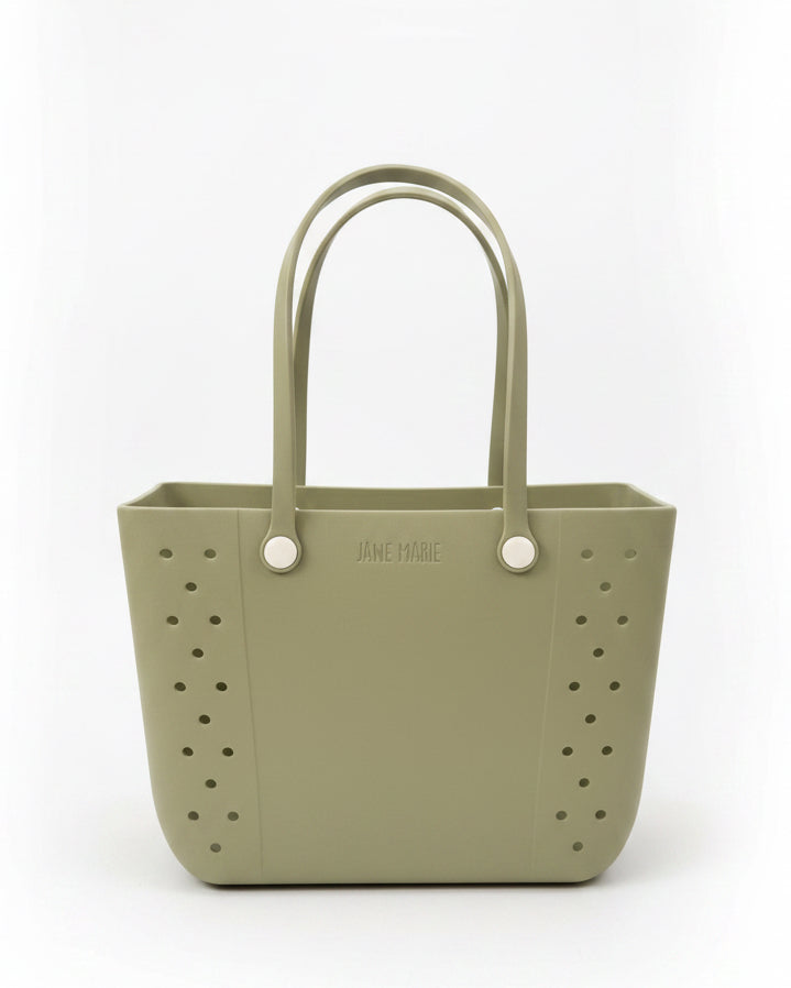 Jane Marie Multi Purpose Tote in sage green with “JANE MARIE” embossed, featuring rubber handles. Available in small and large sizes.