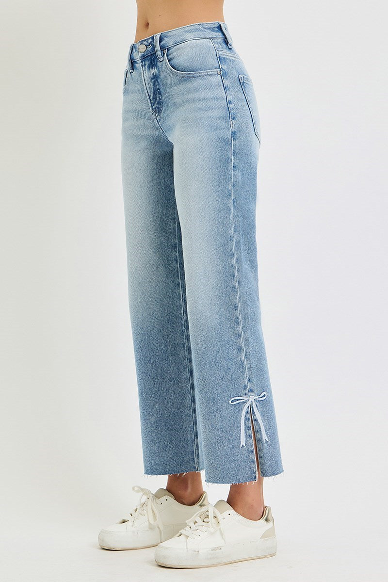 Risen Jeans Tummy Control Straight with Bow in light blue, frayed hems, bow embroidery at ankles. Available in sizes 0–15.