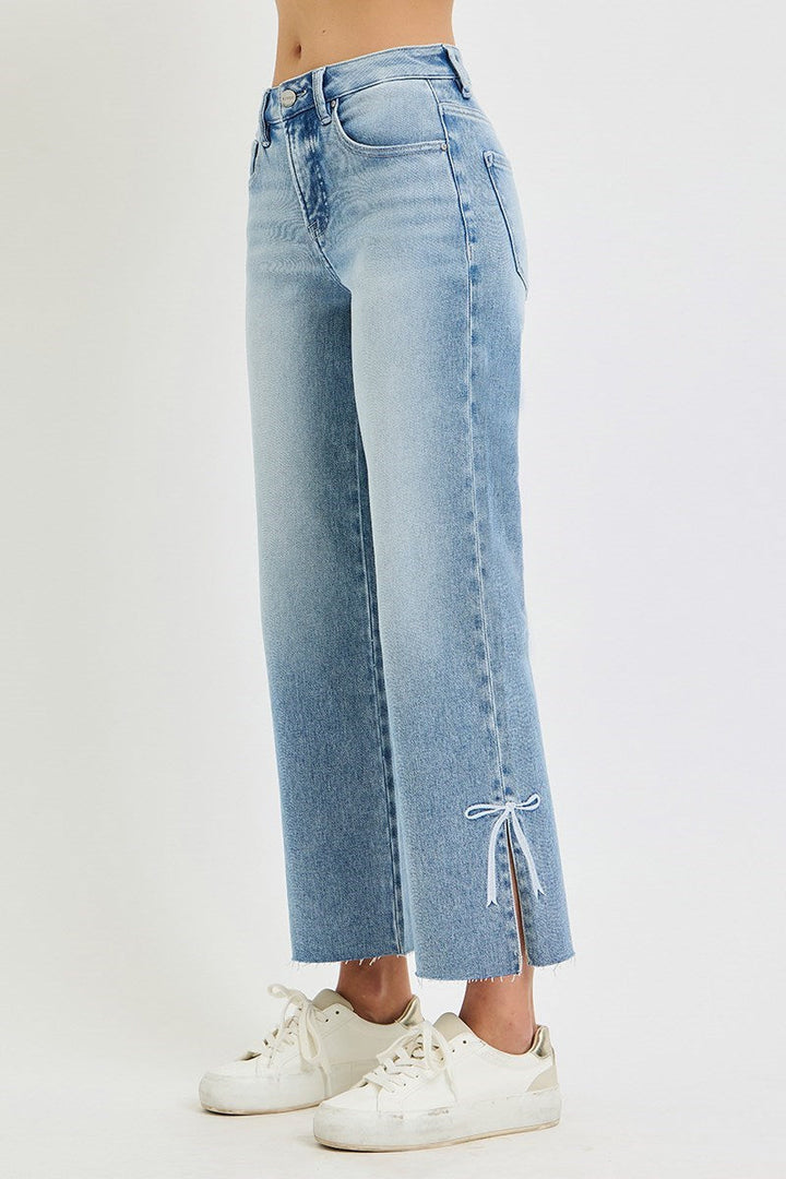 Risen Jeans Tummy Control Straight with Bow in light blue, frayed hems, bow embroidery at ankles. Available in sizes 0–15.