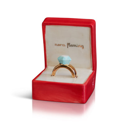 Ceramic diamond ring in a red box with "nora fleming" in gold inside lid. Sizes available: Mini.