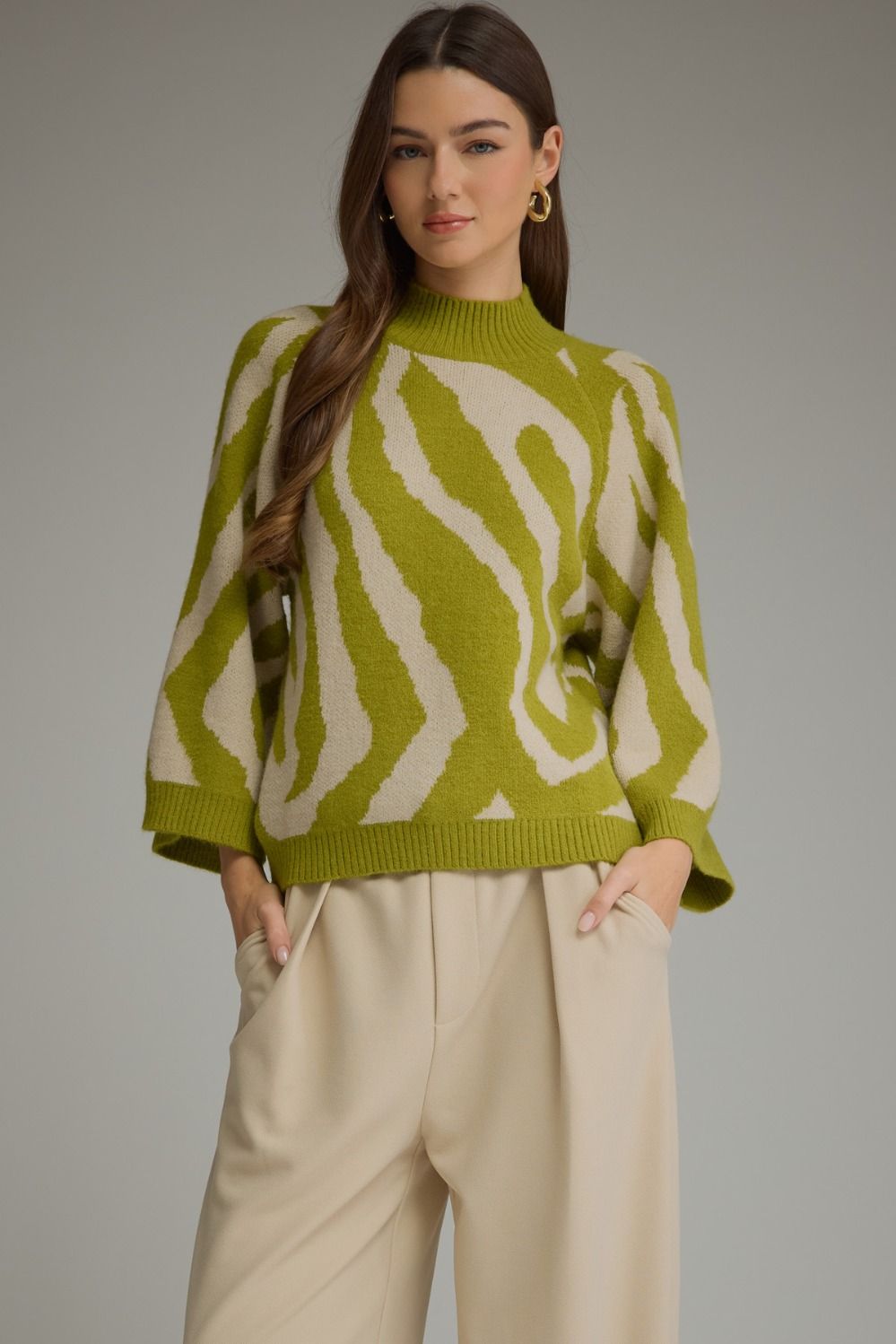 Green and beige zebra print mock neck sweater with bell sleeves. Available in all sizes.