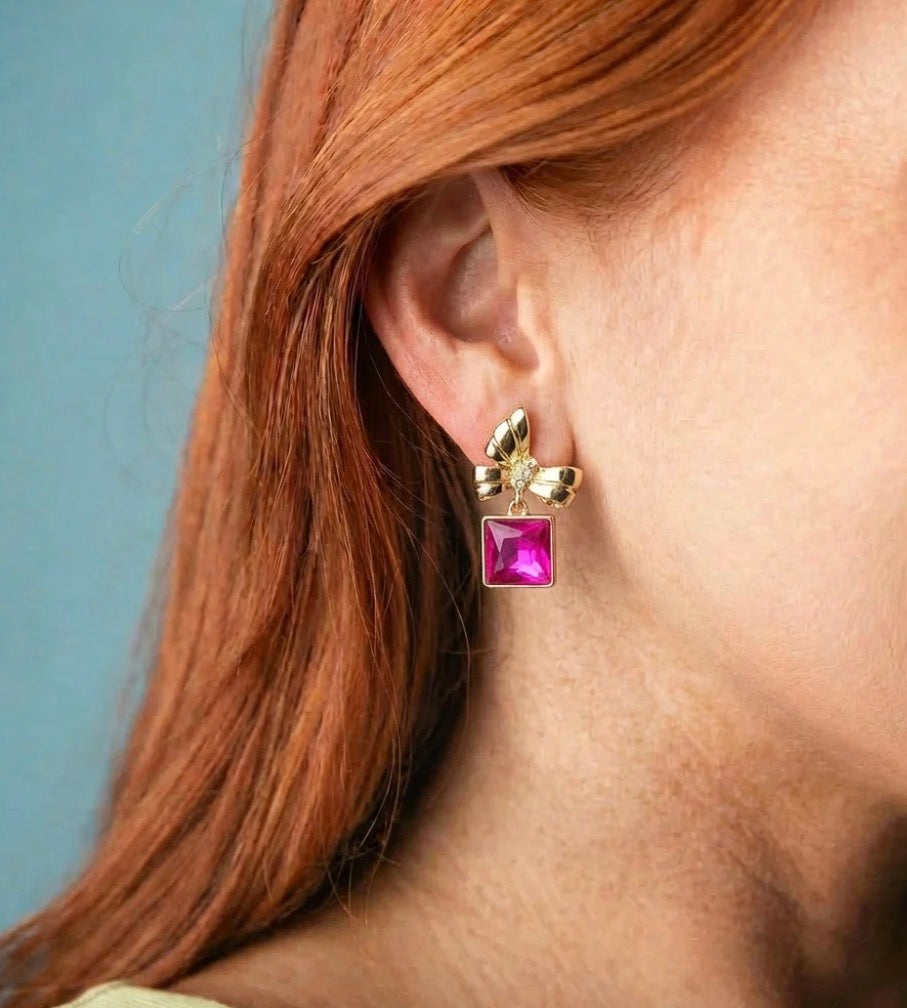 Pink Bow Dangle Earrings: playful gold bows with square hot pink gemstones. Available in small and medium sizes.