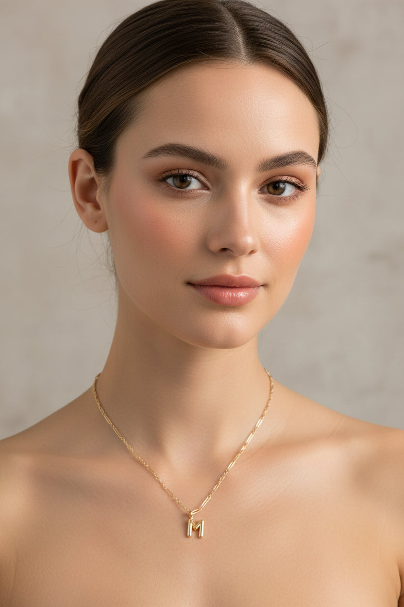 Kendra Scott Bubble Letter Pendant necklace in gold plate with an "M" initial, available in multiple sizes.
