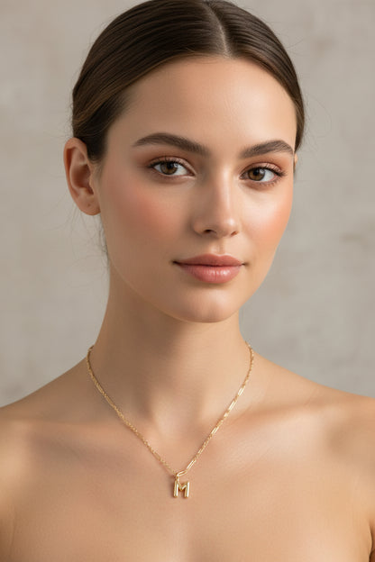 Kendra Scott Bubble Letter Pendant necklace in gold plate with an "M" initial, available in multiple sizes.