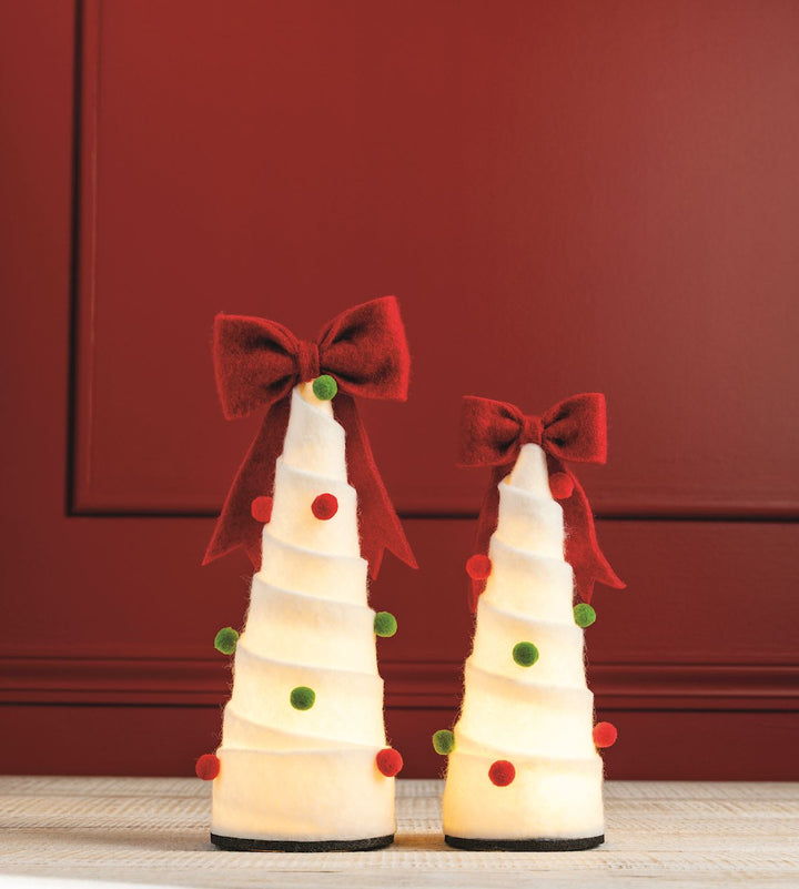 Two LED felted wool pom-pom Christmas trees, white with red and green accents and internal LED lights.