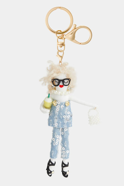 Darling Divas Bag Charm + Key Fob: doll with curly blond hair, sunglasses, sequined overalls, pearl bag, gold clasp. Sizes: varies.