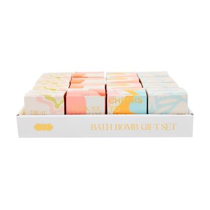 White tray labeled "Bath Bomb Gift Set" holds 12 pastel, scented bath bomb boxes with unique messages. Sizes: standard only.
