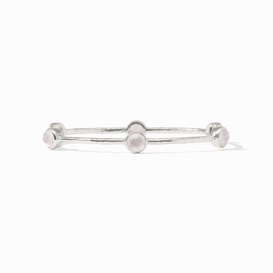 Silver bangle with five round pale pink gemstones on a textured band. Available in small, medium, and large sizes.