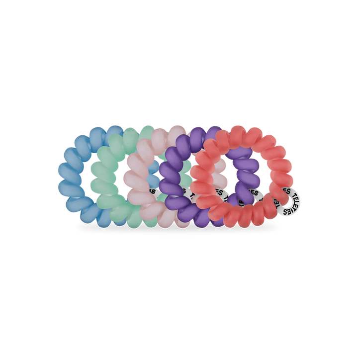 Set of four TELETIES Hair Ties in mint green, light pink, purple, and coral with a white tag. Available in small and large sizes.