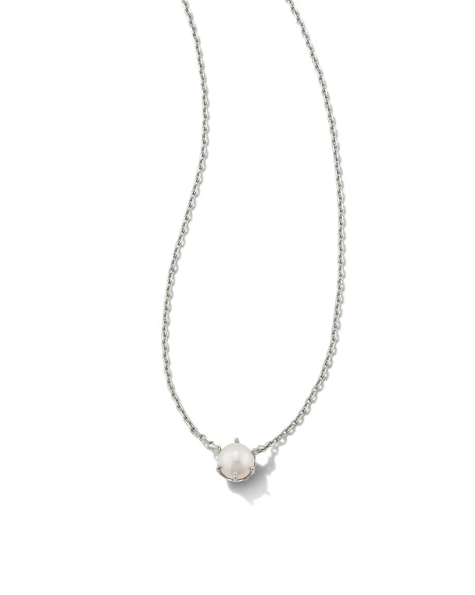 The Ashton Pearl Necklace by Kendra Scott has a thin silver chain and single round white pearl. Available in 16", 18", and 20" lengths.