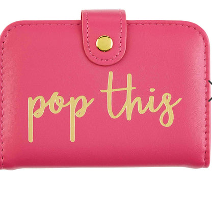 Pink wallet-style pill case with gold snap button, “pop this” in yellow script. Available in small and large sizes.