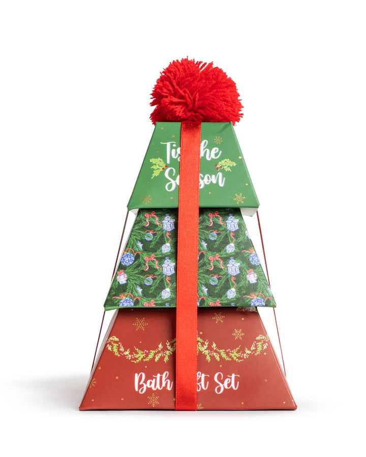 ‘Tis The Season Bath Gift Set | Winter Wishes, a three-tiered, triangular Christmas tree-shaped gift box with a red pom-pom and ribbon.