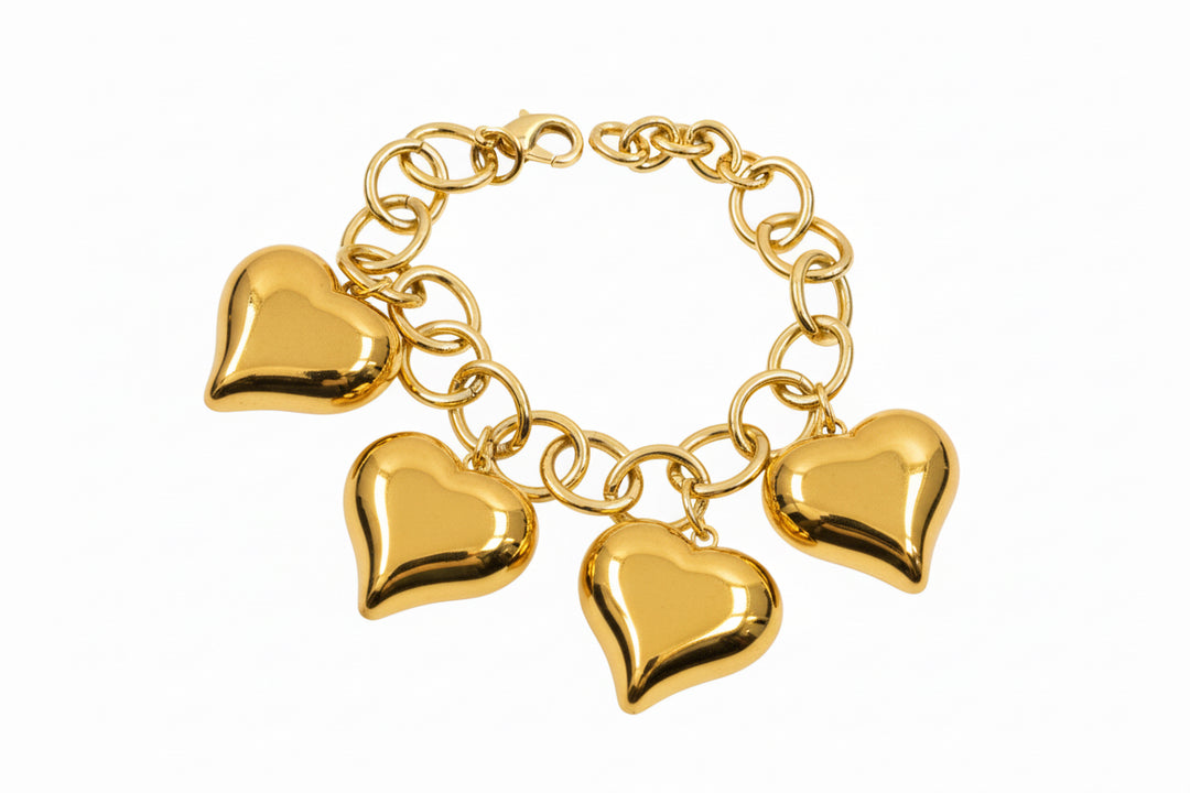 Gold chain bracelet with four large, shiny heart-shaped charms. Available sizes: S, M, L.