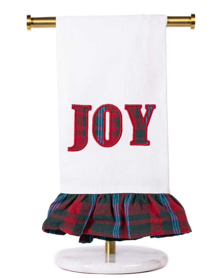 White Joy Ruffle hand towel with red “JOY” embroidery and ruffled red and green plaid trim.