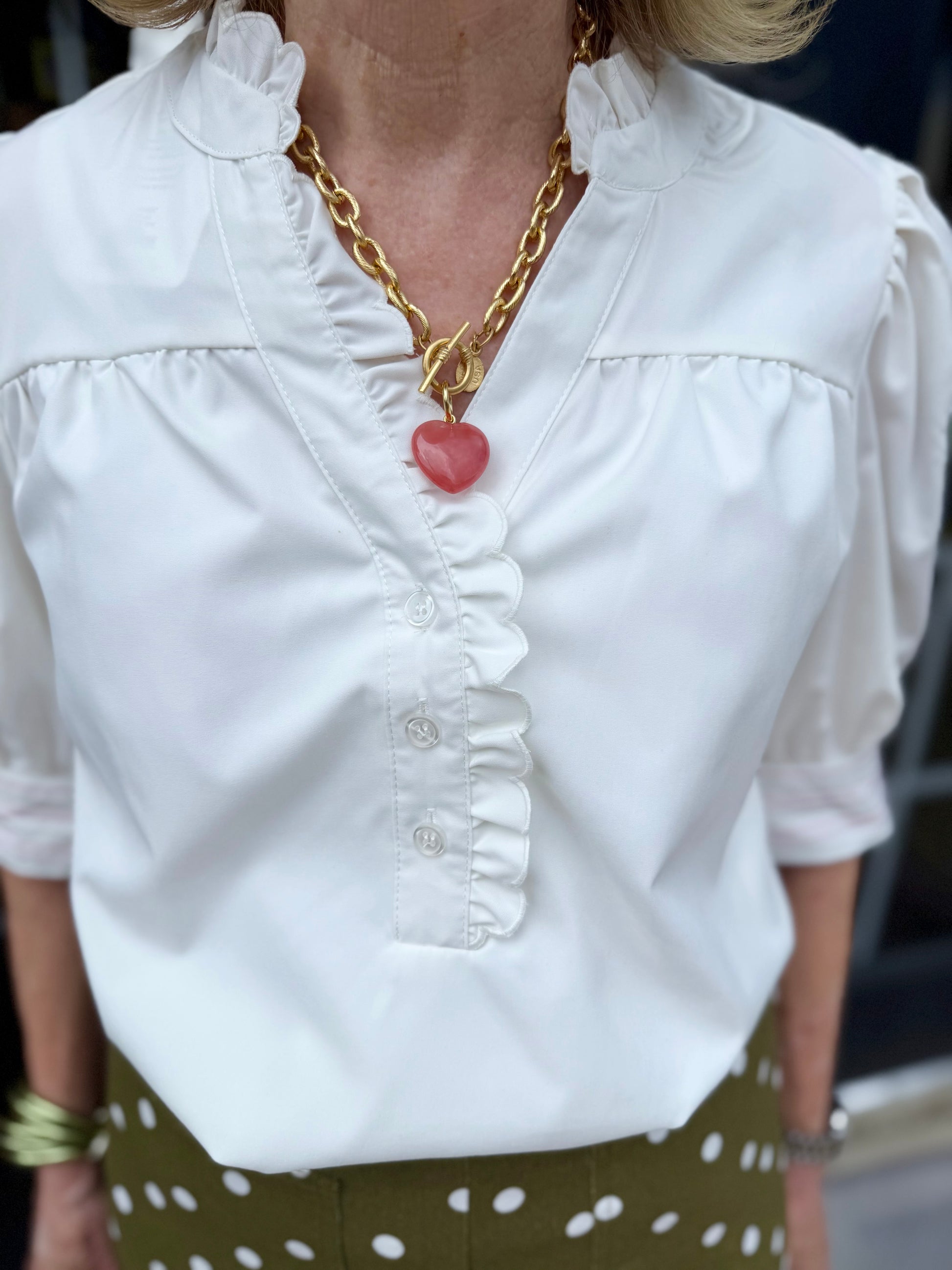 Emmie Ivory Top with ruffle neckline, available in sizes XS-XL.