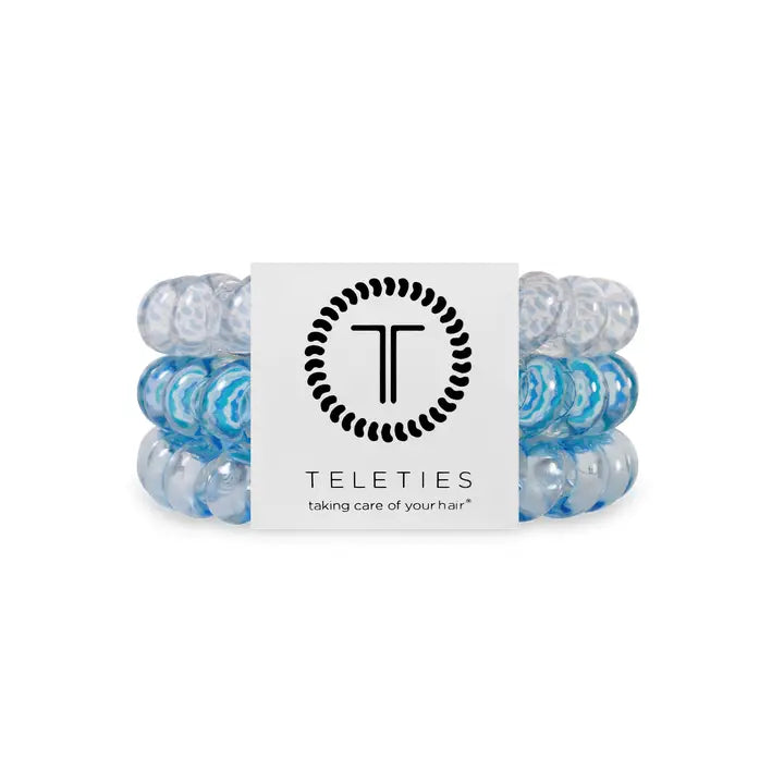 Three blue and clear TELETIES Hair Ties on branded card. Available in small, medium, and large sizes.