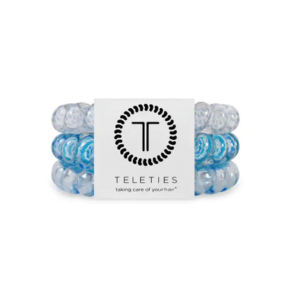 Three blue and clear TELETIES Hair Ties on branded card. Available in small, medium, and large sizes.