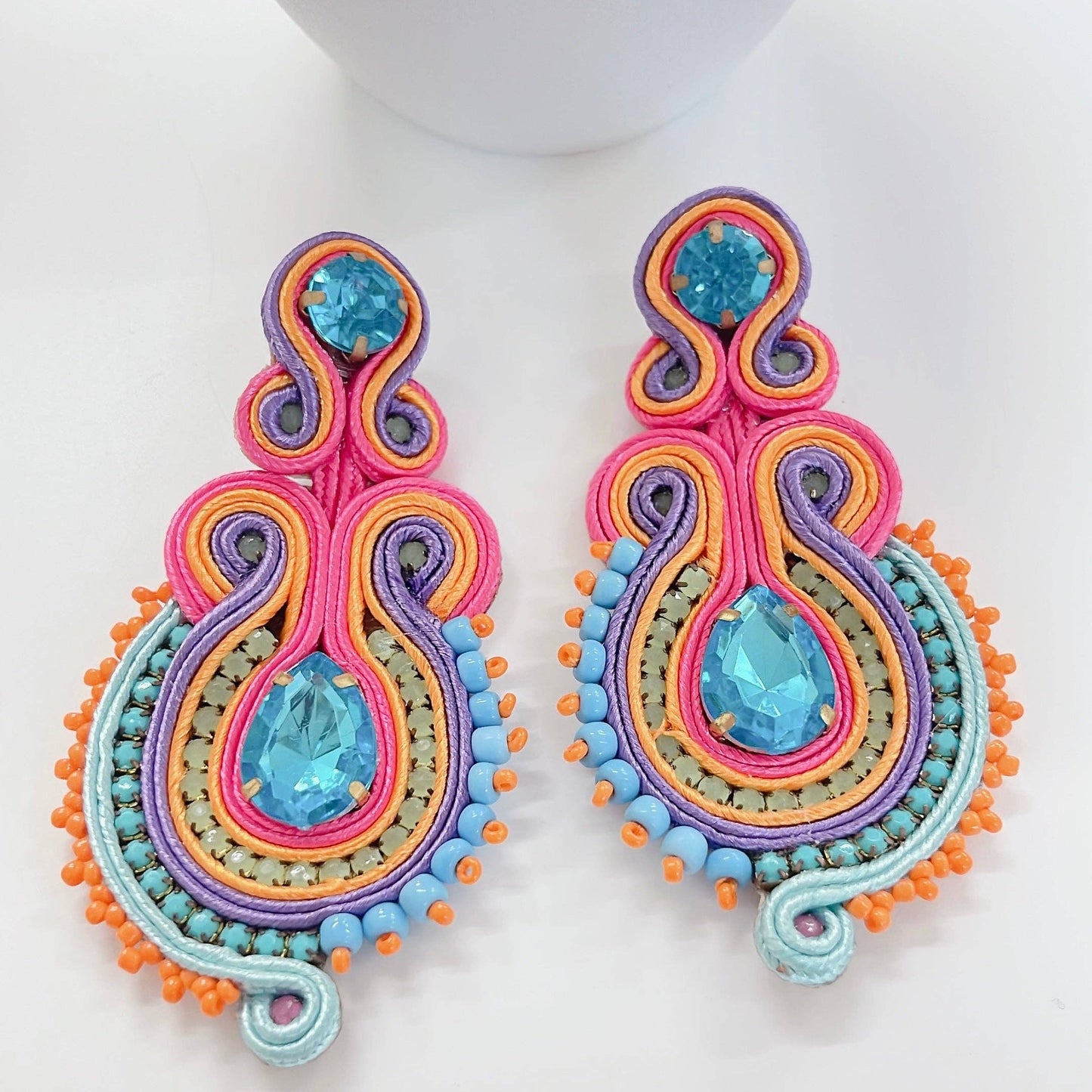 Courtney Multi Earrings: pink, orange, purple, blue beads with teardrop blue gems. Available in one size.