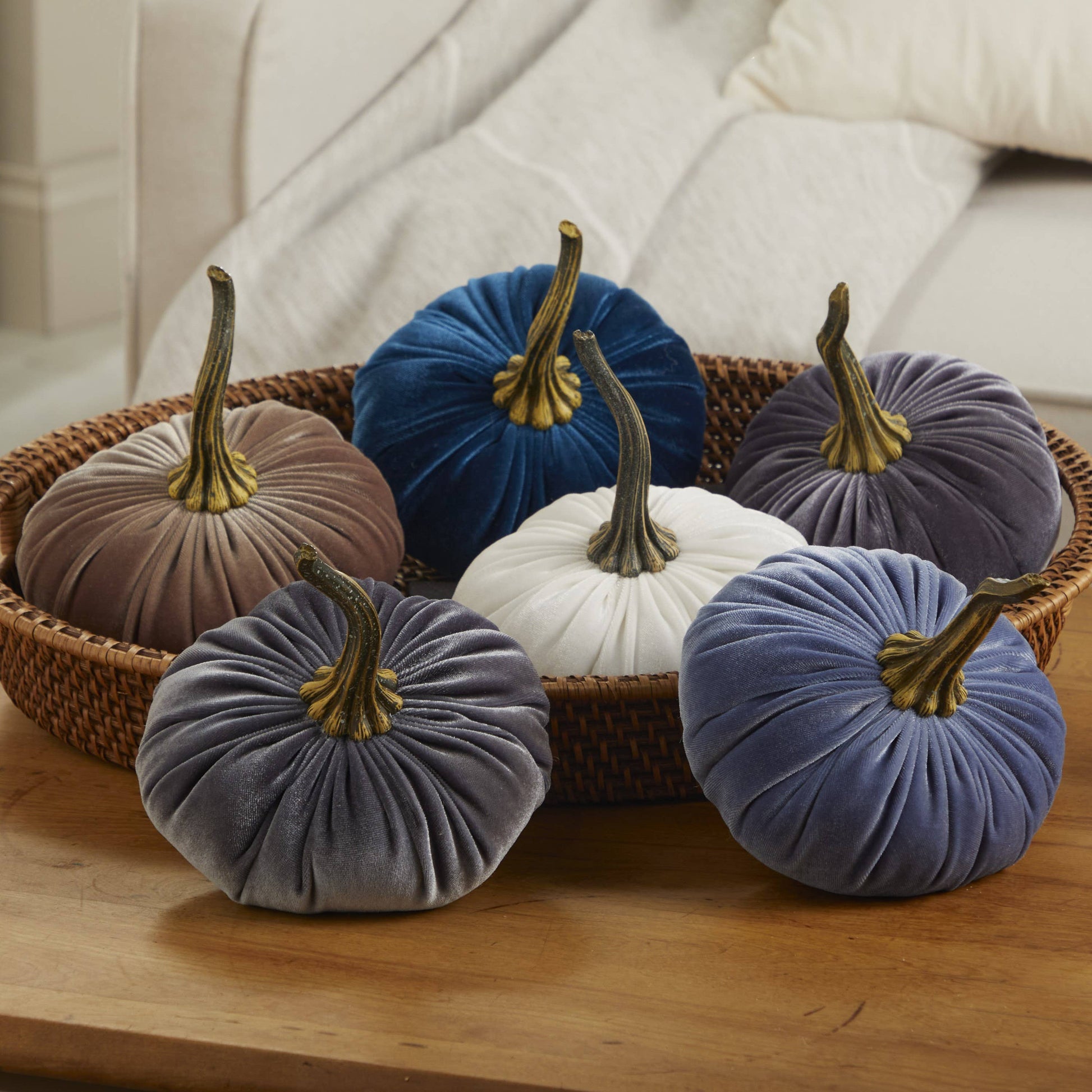 Six large velvet pumpkins in blue, brown, gray, white, and purple displayed in a wicker basket. Available in multiple sizes.