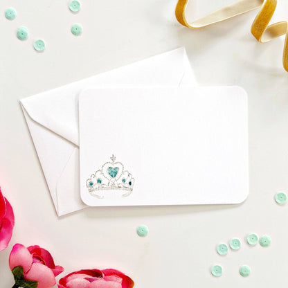White notecard and envelope with tiara, pink flowers, sequins, and gold ribbon. Available in 4x6" and 5x7" sizes.