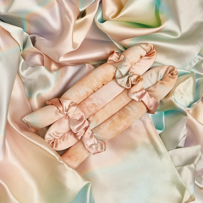 The Satin Heatless Curling Set - Sunset Tie Dye includes three peach satin curlers and matching scrunchies. Sizes: S, M, L.