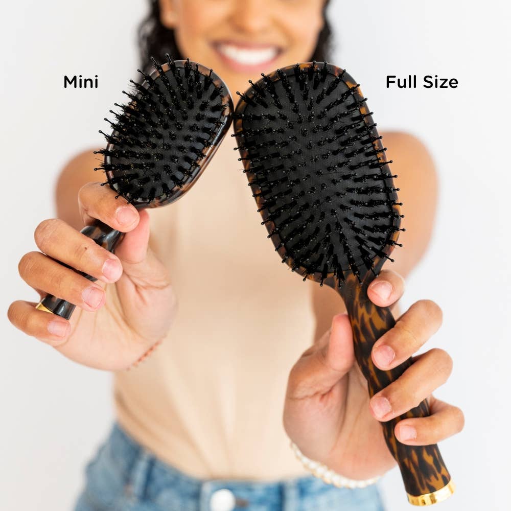 Mini Boar Brush | Tortoise hairbrush shown next to a full size version, highlighting the compact travel size and regular size options.