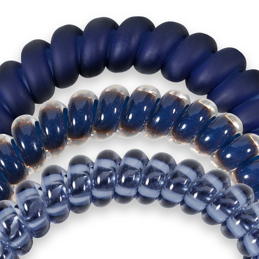 Small Spiral Hair Coils in Nightfall Navy: one navy, one transparent blue-tinted, one clear light blue. Available in small size.