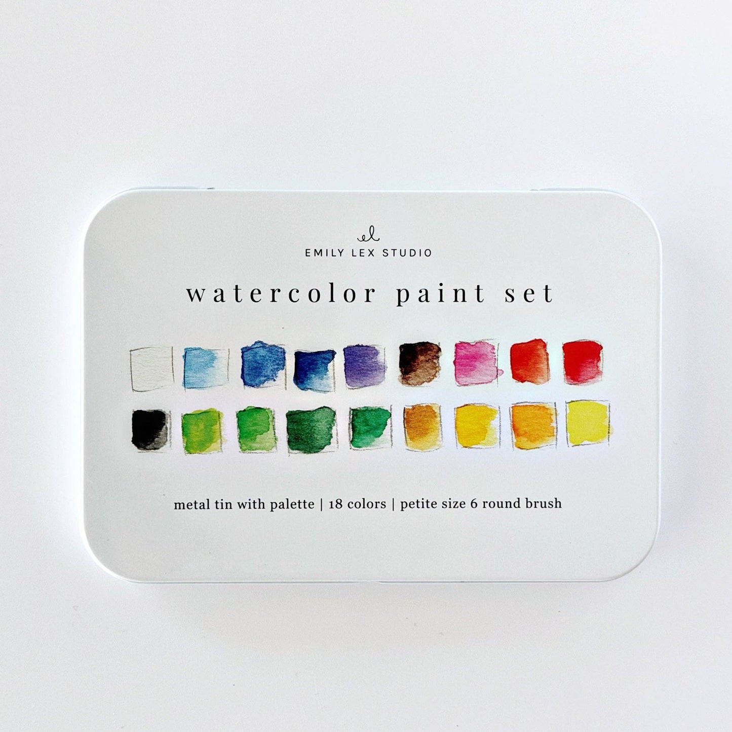 White metal tin labeled “Watercolor paint set 18 colors with brush” from Emily Lex Studio contains a compact palette with 18 vibrant colors and a size 6 round brush in petite sizing.