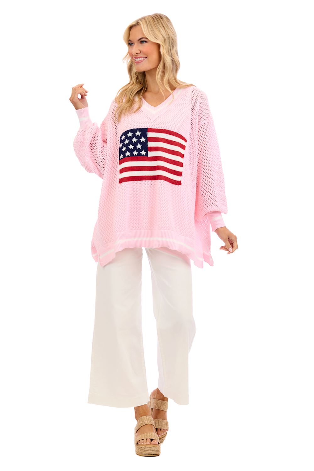 Americana Flag Sweater: loose, light pink open knit V-neck with American flag design. Available in sizes XS–XL.