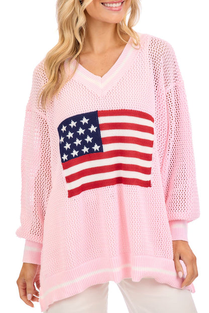 Loose, light pink Americana Flag Sweater with large American flag on front. Available in sizes XS–XL.