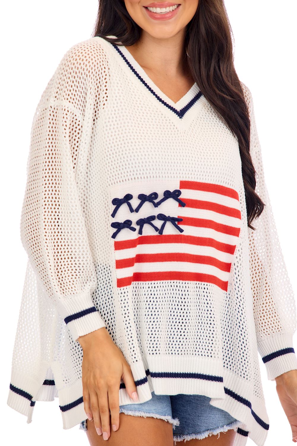 Americana Flag Sweater: loose V-neck knit, navy trim, American flag design. Available in sizes XS–XL.