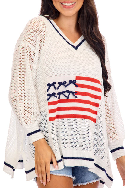 Americana Flag Sweater: loose V-neck knit, navy trim, American flag design. Available in sizes XS–XL.