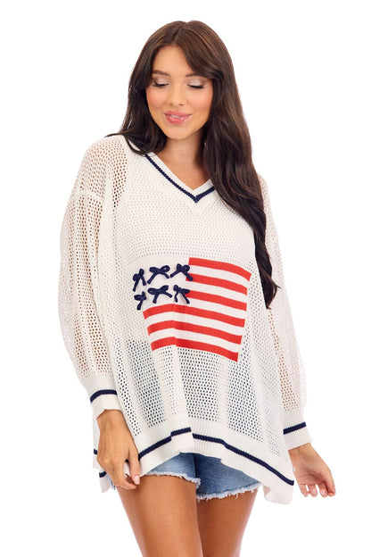 Americana Flag Sweater: loose V-neck, navy trim, red-and-white stripes. Available in sizes XS-XL.
