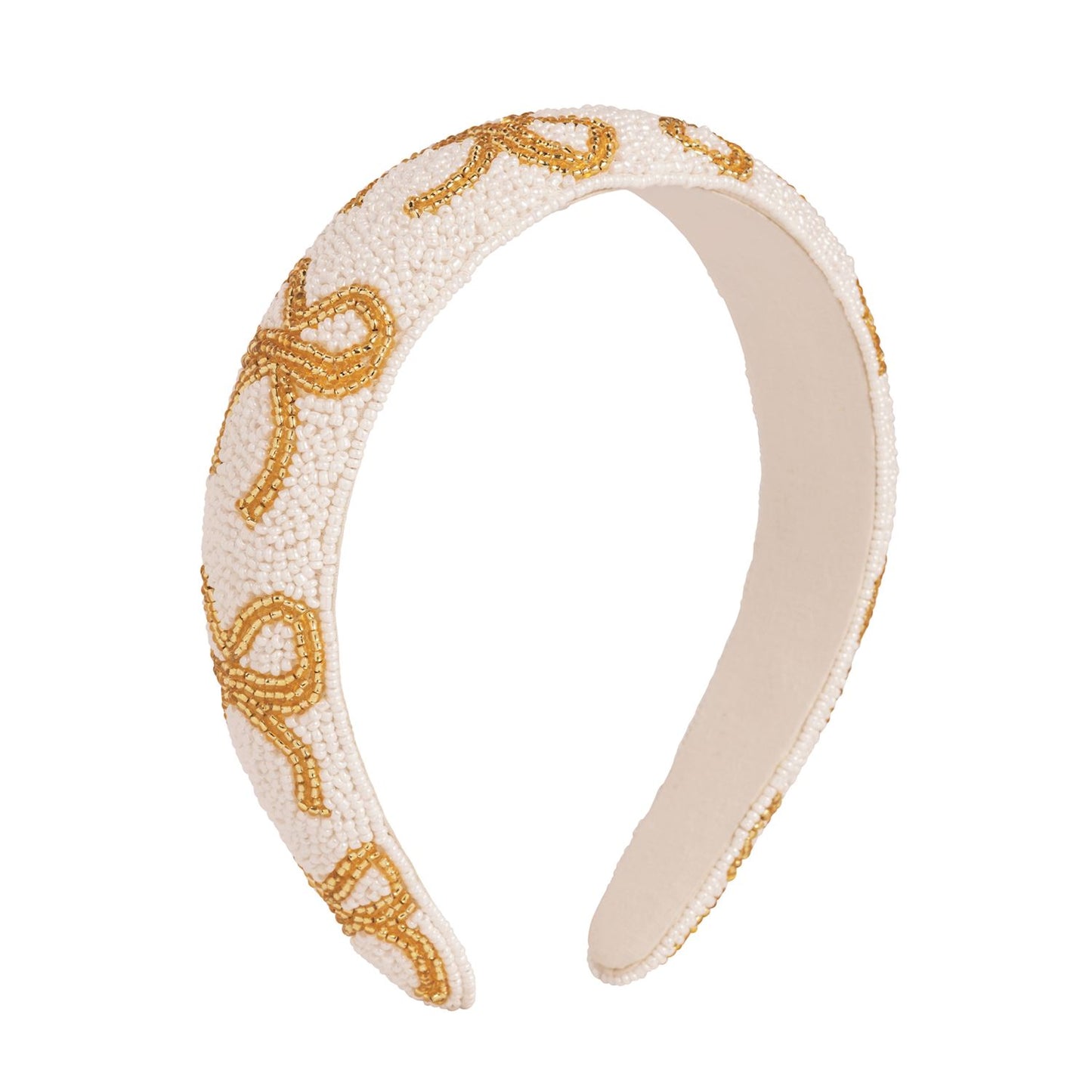 Padded white headband with hand-beaded gold bow designs. Available sizes: S, M, L.