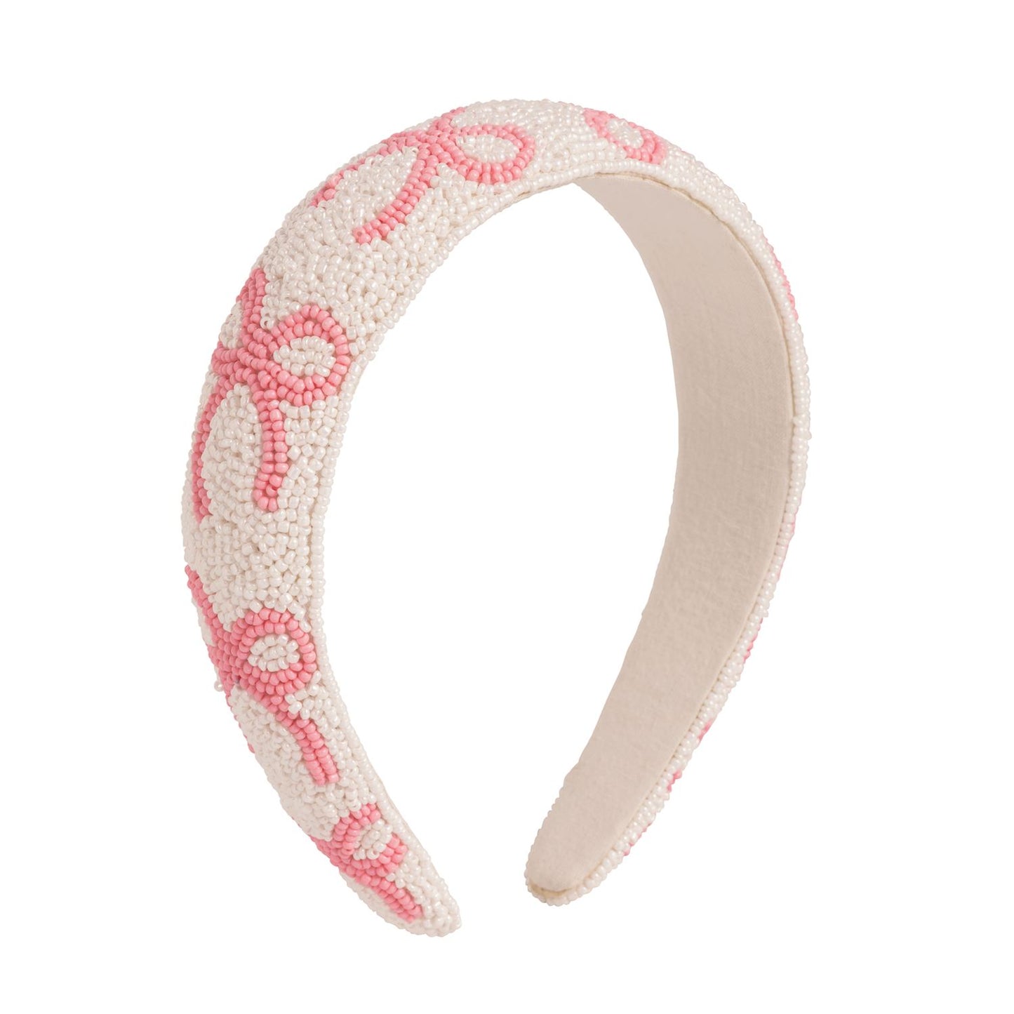 White fabric headband with small white beads, pink beaded swirls, and a hand-beaded bow. Available in one size.