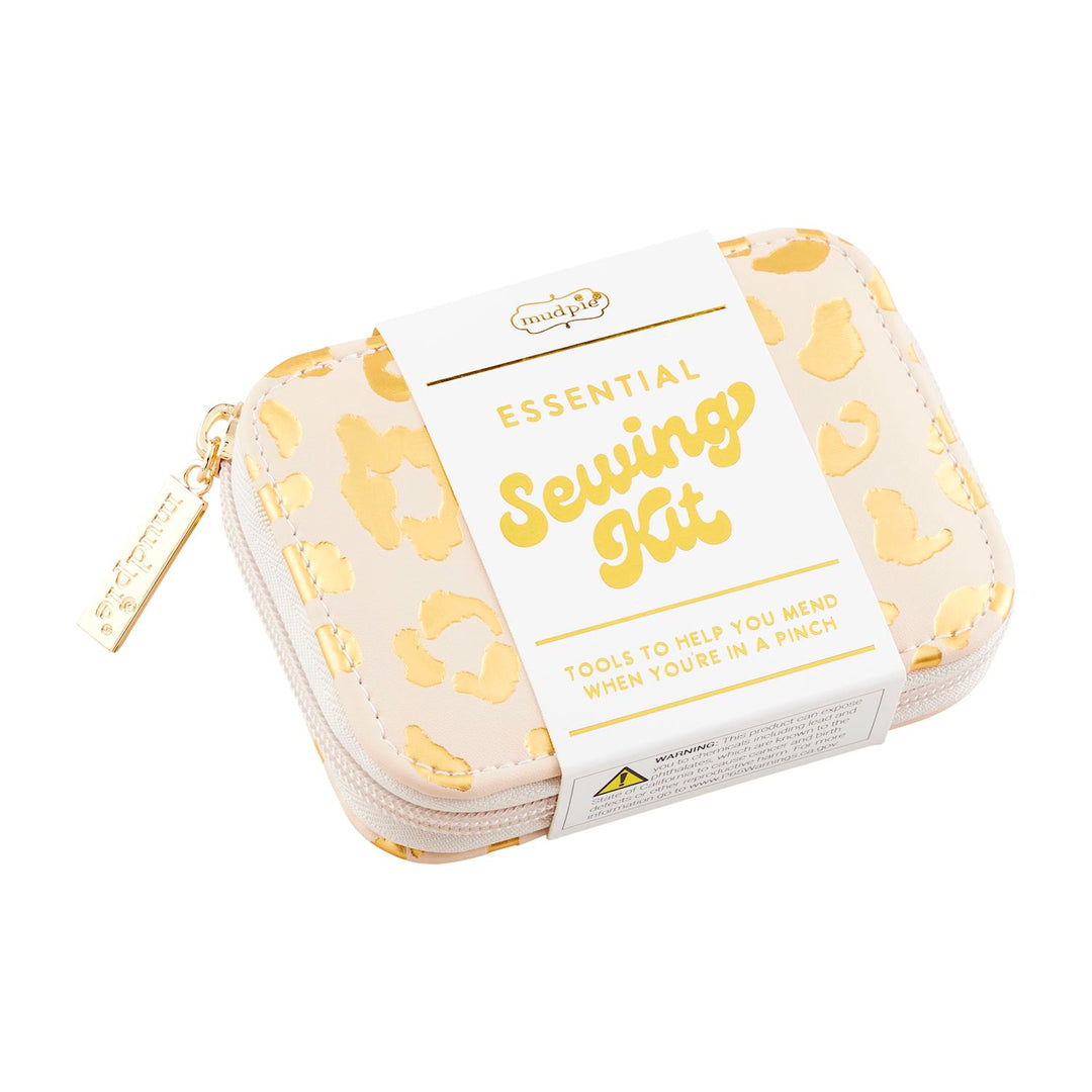 Compact rectangular sewing kit with beige faux leather case featuring gold abstract patterns. Golden zipper pull, white label reading "Leopard Sewing Kit" and "Tools to help you mend when you&