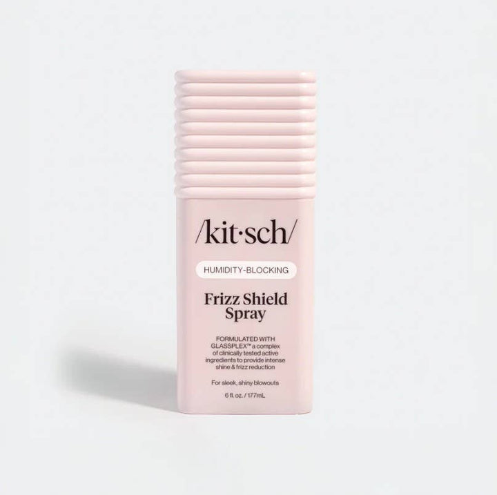 Light pink, 6-ounce rectangular Humidity Blocking Frizz Shield Spray bottle with a ribbed cap.